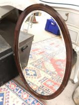 A wooden inlaid oval mirror,80cm tall 50cm wide