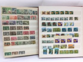 Two albums containing postage stamps of Rhodesia,