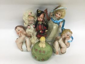 Two porcelain piano dolls, a tidy jar and three sm