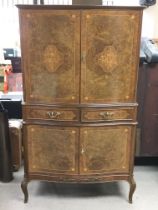 An inlaid Walnut burr cocktail cabinet with glass