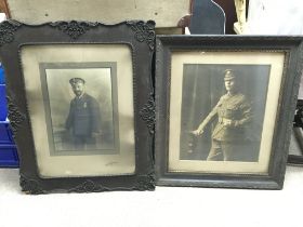 Framed WW1 photographs of a soldier and a navy off