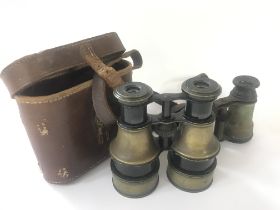 A cased pair of Hughes brass body field binoculars