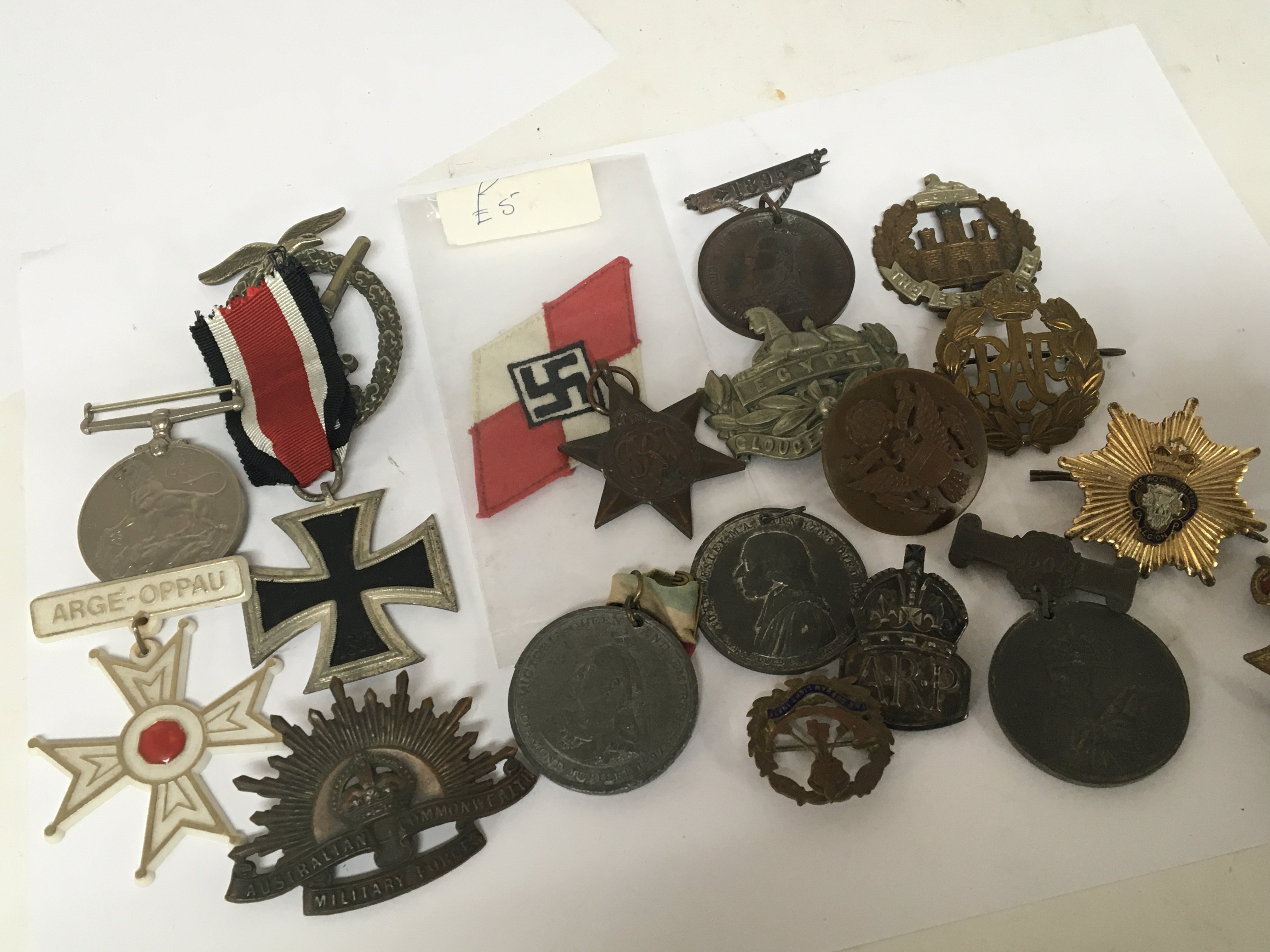 A collection of military badges and medals commemorative medals and other related items.