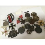 A collection of military badges and medals commemorative medals and other related items.
