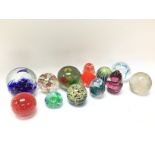 A collection of various vintage paperweights. Post