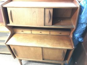 A teak mid 20th century cabinet with sliding doors