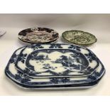 A collection of meat plates and decorative plates.