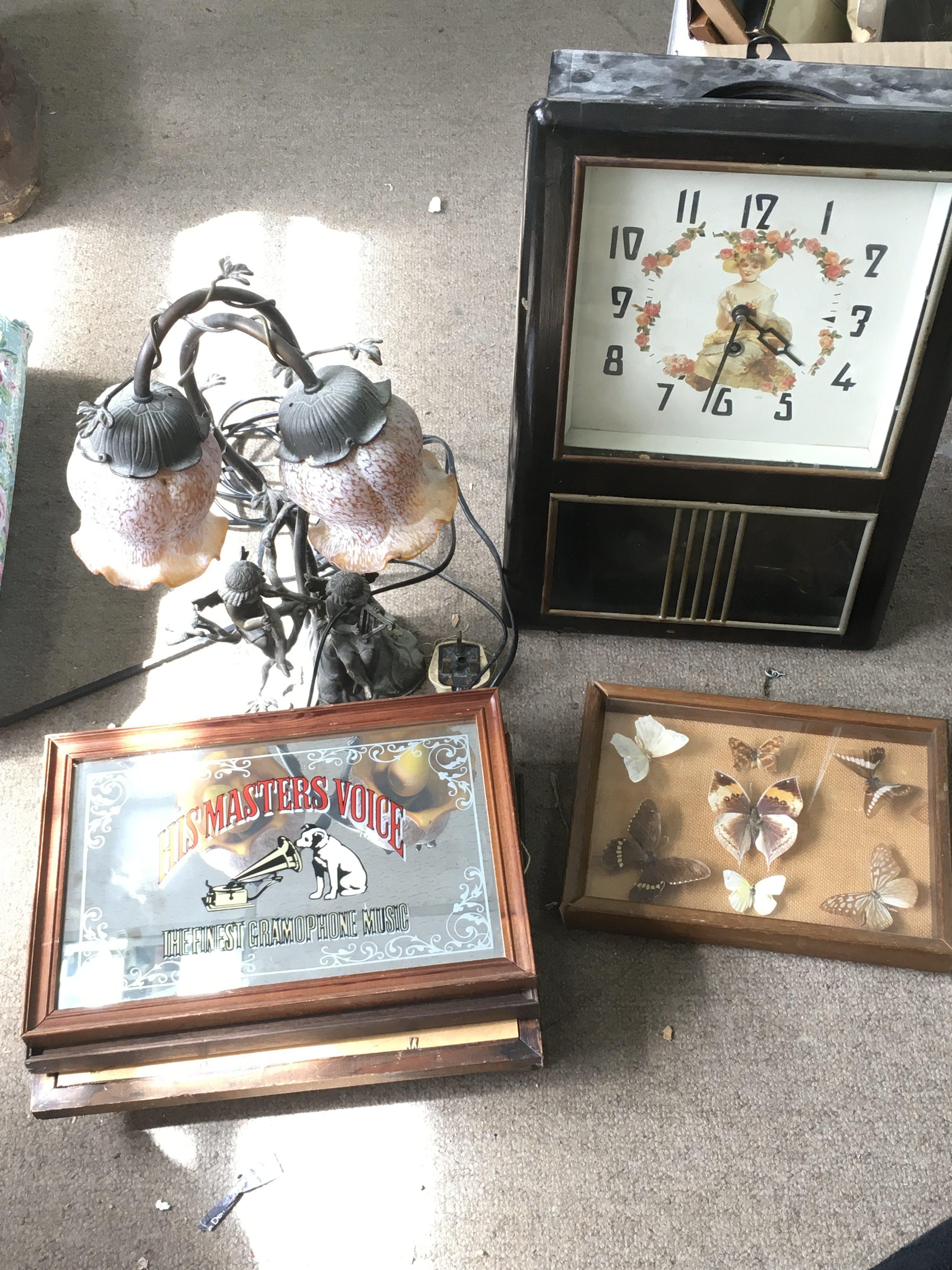 A collection of vintage items including a modern wall clock with art nouveau style design, bronze