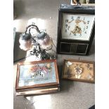 A collection of vintage items including a modern wall clock with art nouveau style design, bronze