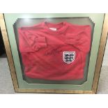 A framed England football jumper signed by Geoff H