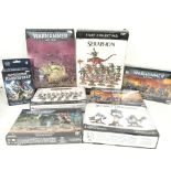 A Collection of Boxed Warhammer Figures.