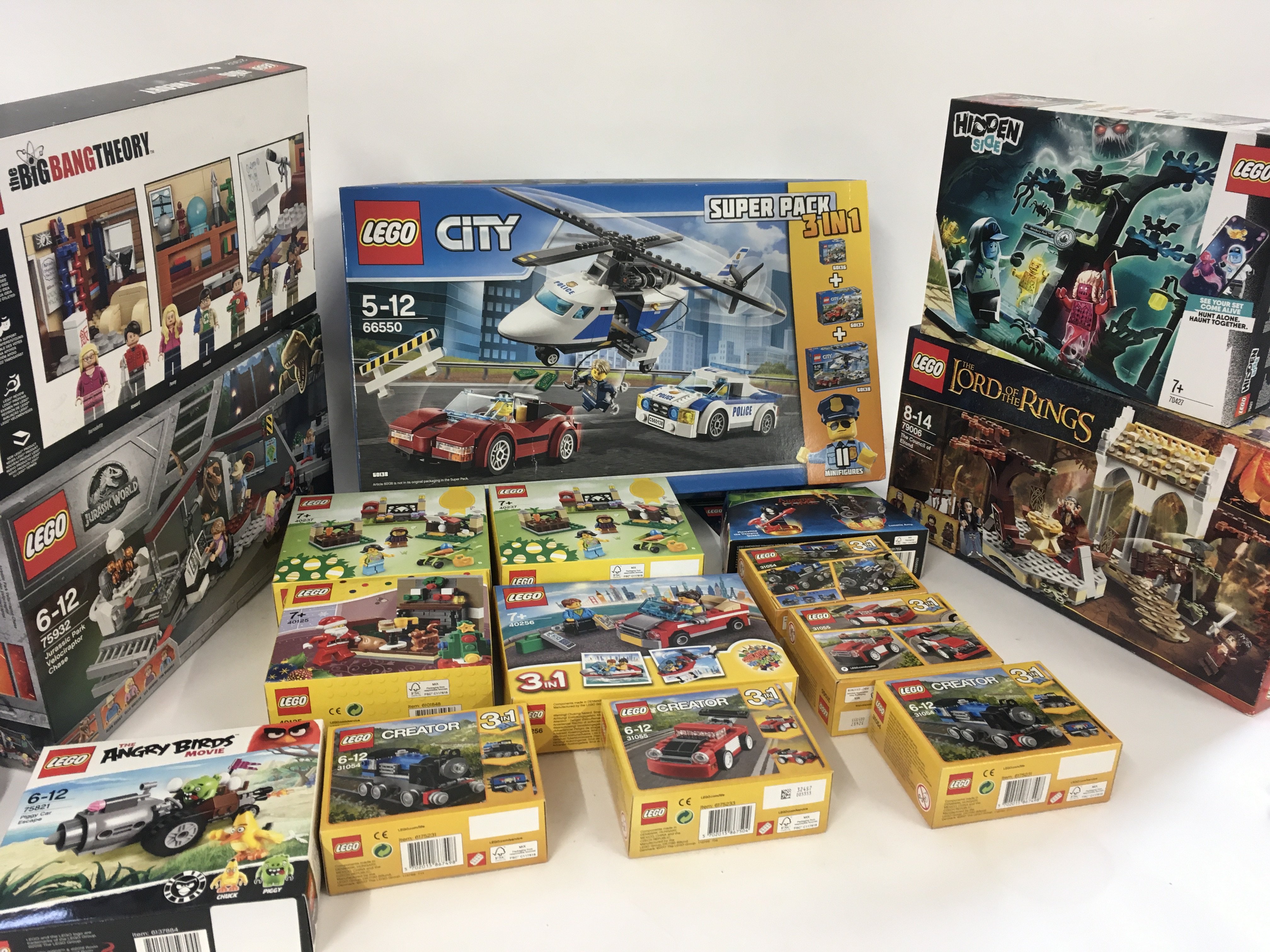 A collection of 18 unopened Lego sets with numerou