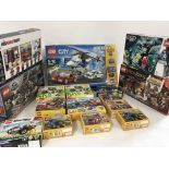 A collection of 18 unopened Lego sets with numerou