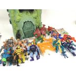 A Collection of He-Man Figures and a Castle Greysk