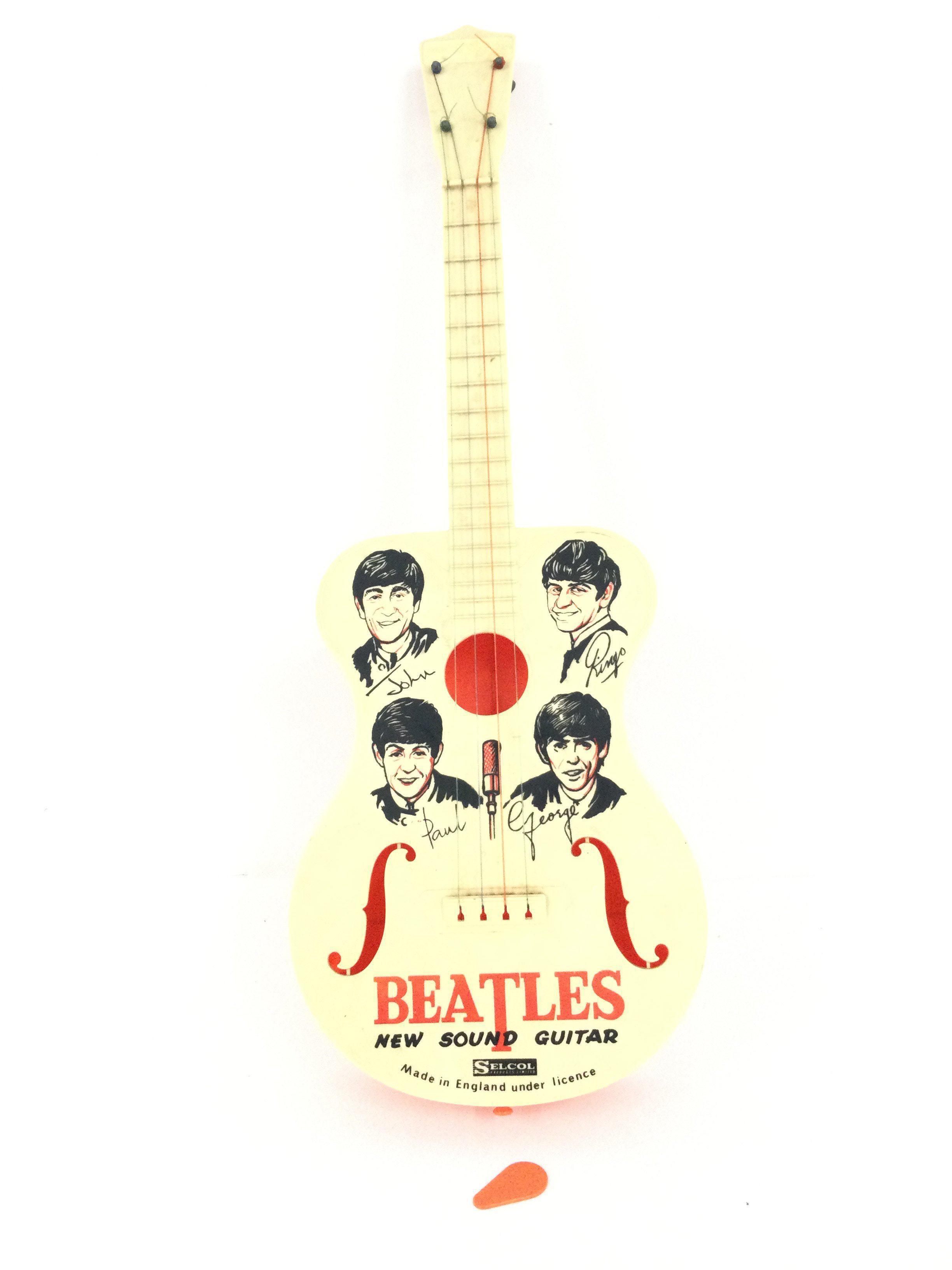 A 1963 Selcol Beatles Child Guitar With Plectrum.