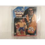 WWF JIM THE ANVIL NEIDHART. Unopened in original blister packaging and mounted within a acrylic