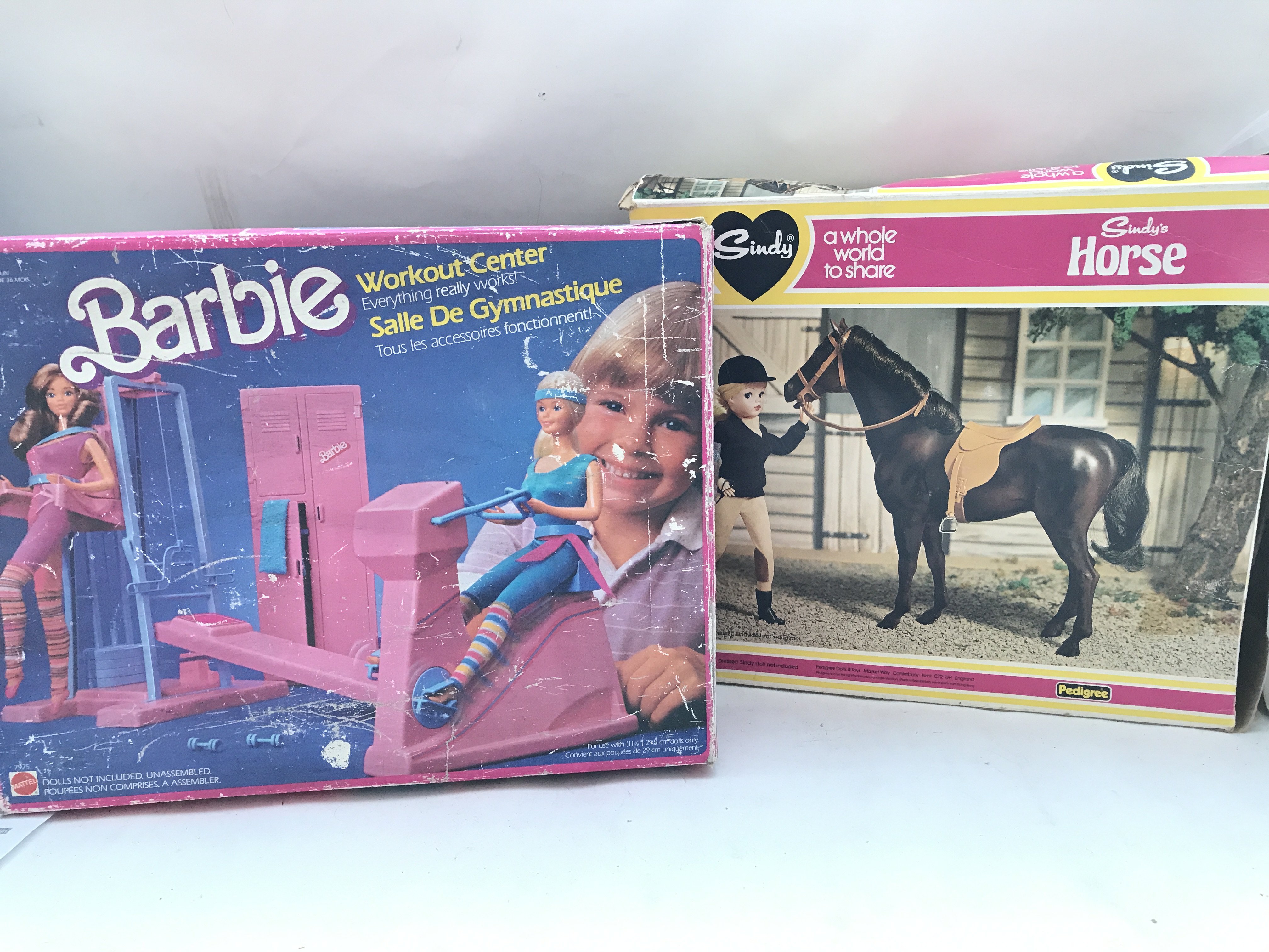 A Boxed Barbie Workout Centre and a Sindy Horse.