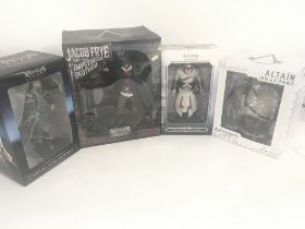 A collection of four boxed ASSASSINS CREED figures