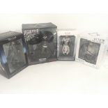 A collection of four boxed ASSASSINS CREED figures