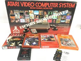 A Boxed Atari CX-2600 with Games.(2).