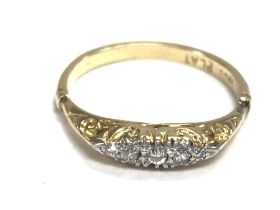 An 18ct gold ring set with small diamonds. Size P