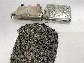 A silver chain mail purse one other purse and a ci