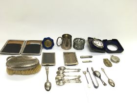 A collection of items including silver Frames spoo