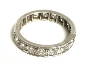 A white metal eternity ring set with a row of diam