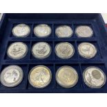 12 cased 1oz fine silver coins to include 7 Britta