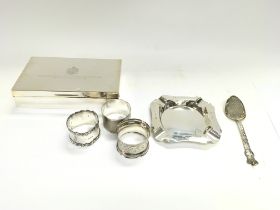 A silver cigarette box three napkin rings a silver