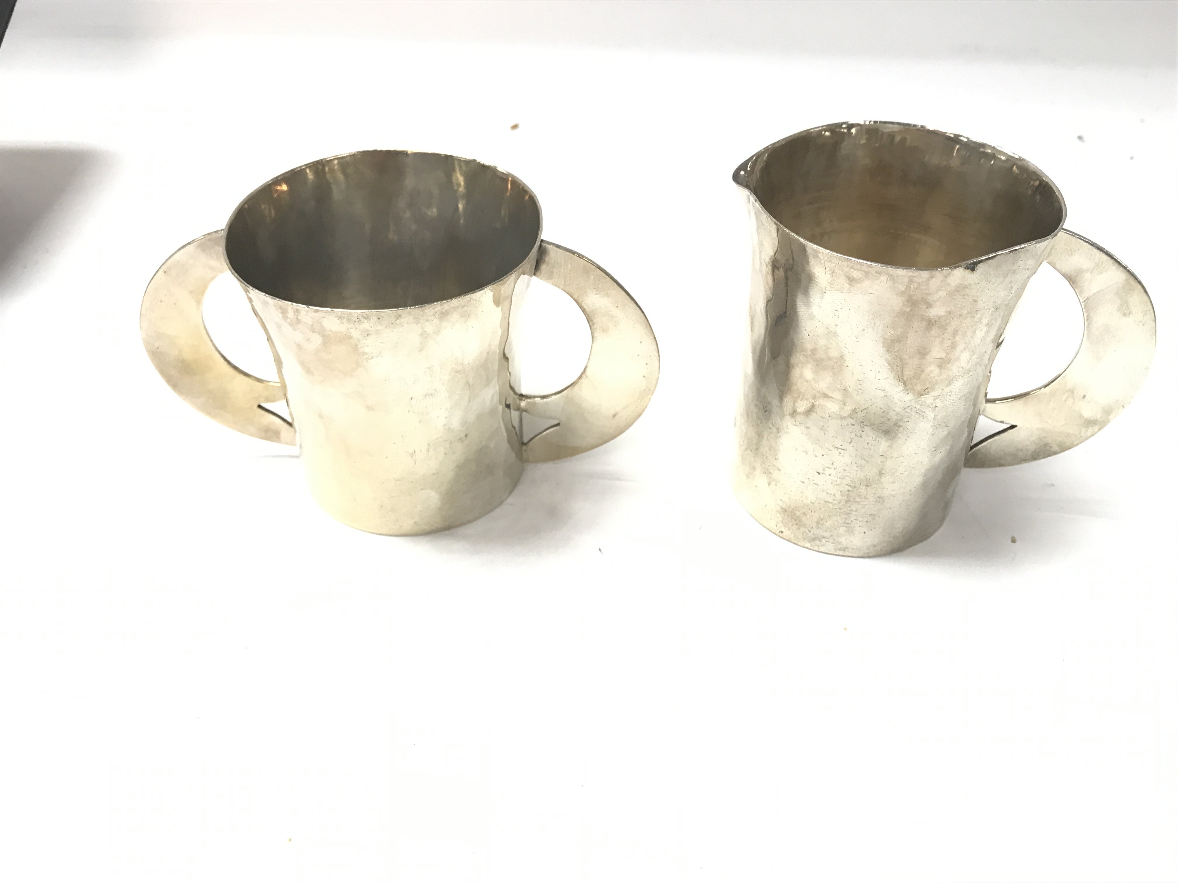 A white metal jug and double handled mug with hamm