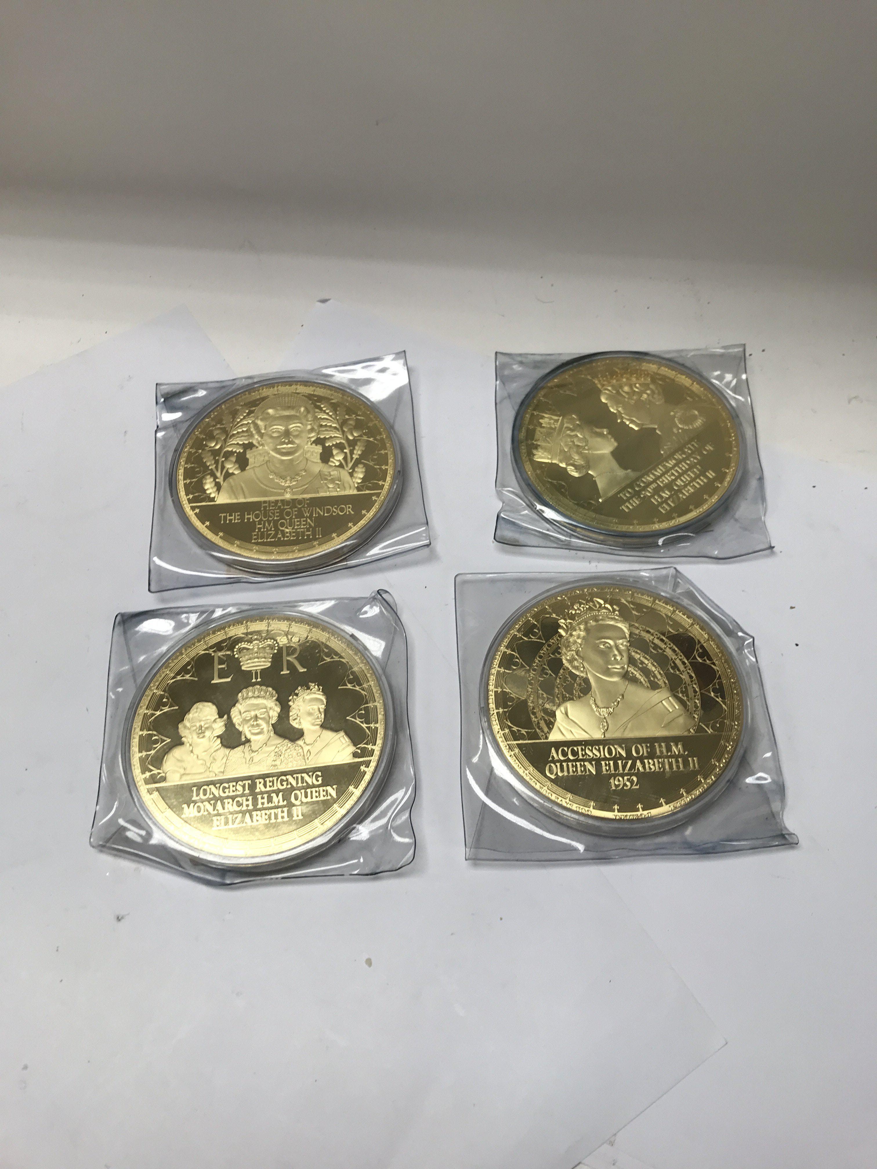 A collection of large gold plated commemorative me