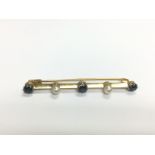 A gold bar brooch set with sapphires and pearls, a