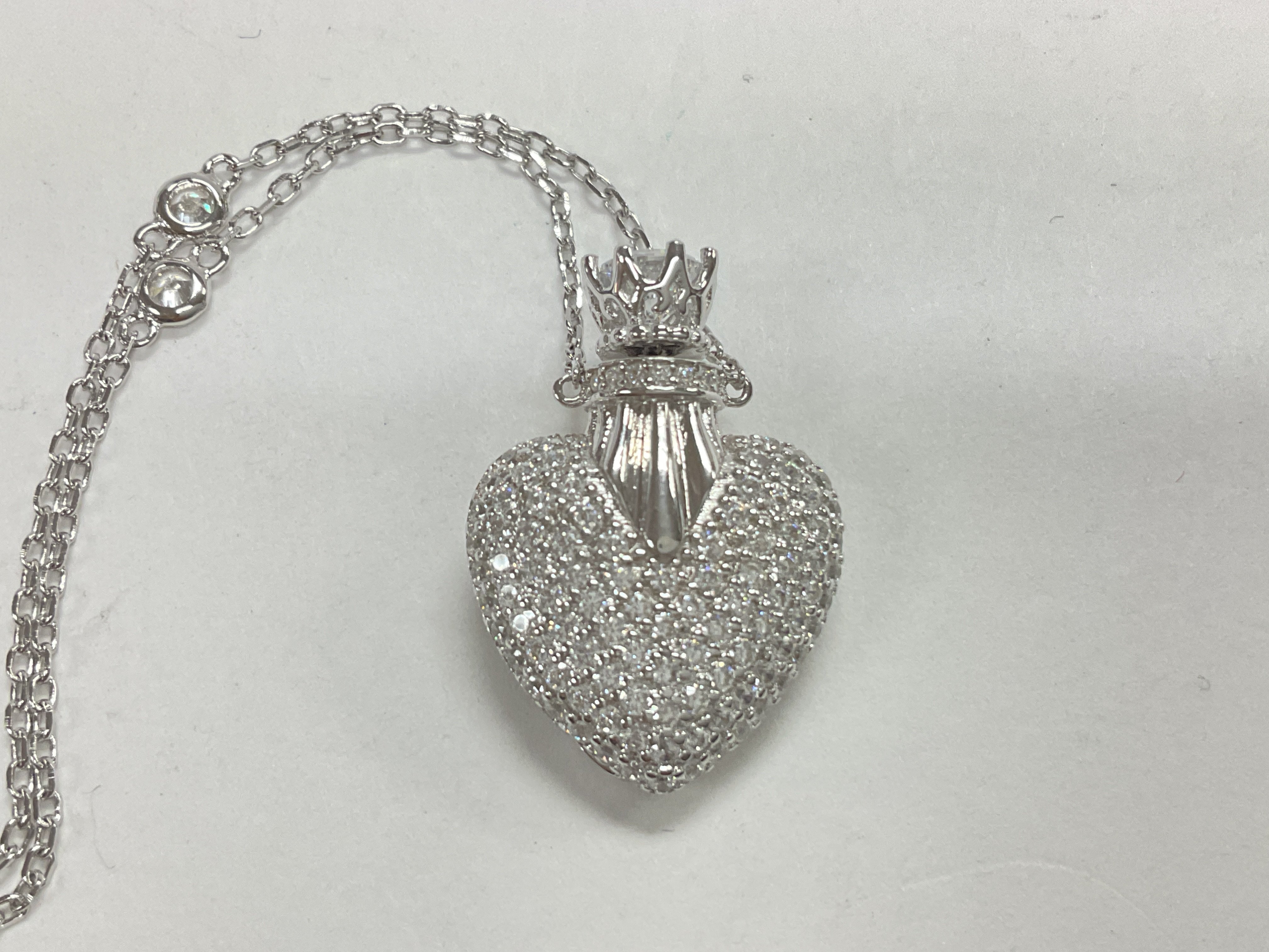 Silver necklace with heart shaped locket pave set
