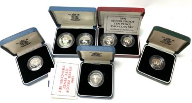 A collection of Royal mint cased silver proof coin