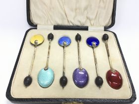 A boxed set of six enamelled spoons. Postage B