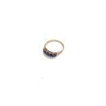 An unmarked 9ct gold ring set with five blue stone