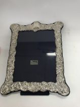 A 925 sterling silver photo frame with floral desi