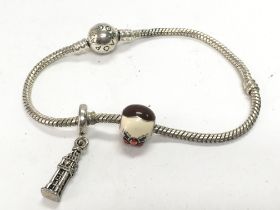 A Pandora bracelet with two attached charms. Posta