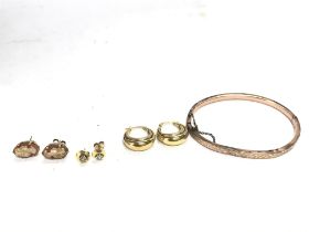 A collection of 9ct gold items including a bangle