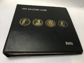 An album filled with coins and other loose coins.