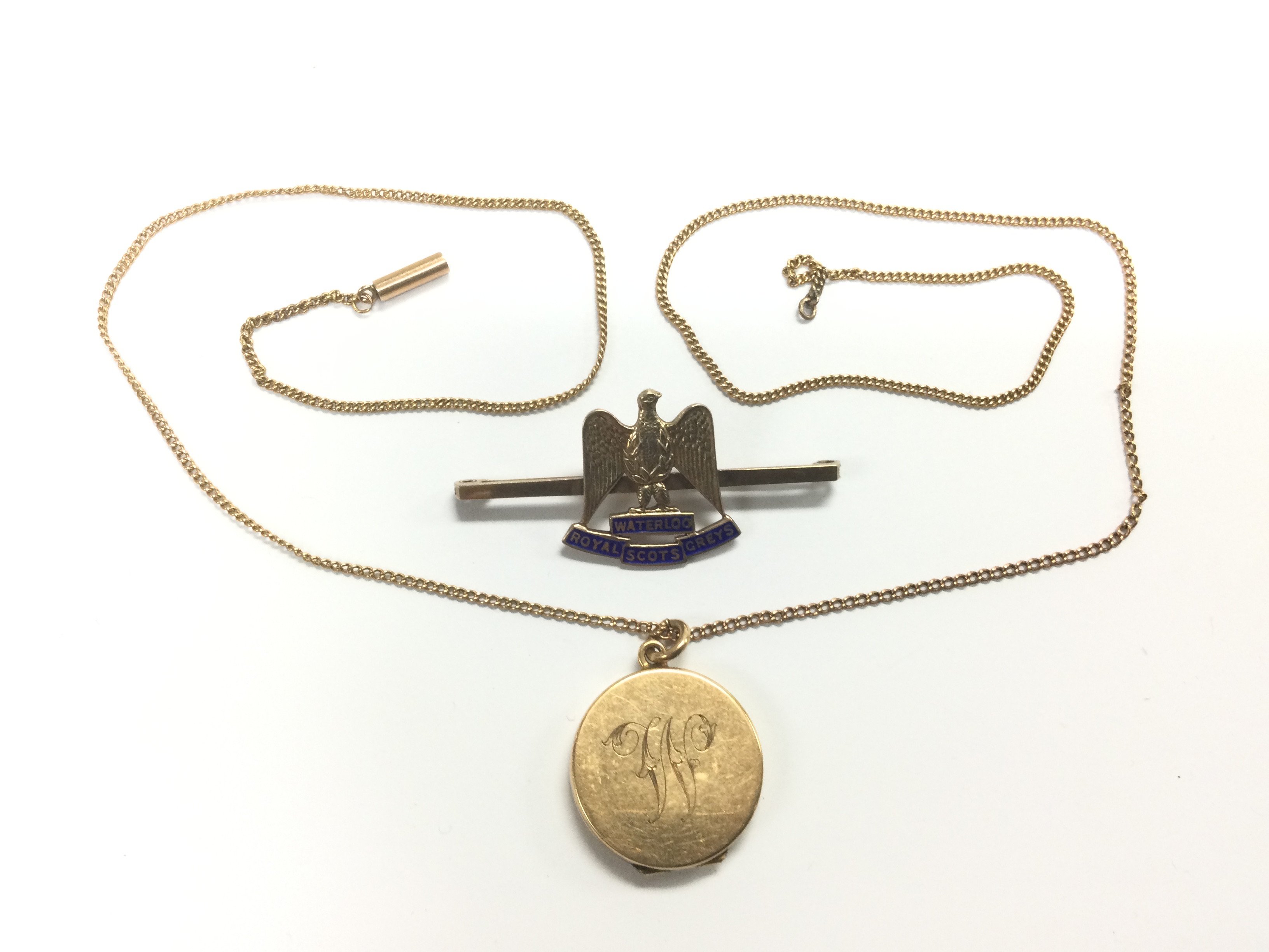 A 9ct gold locket and chain and a Royal Scots Grey