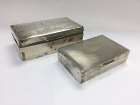 A silver cigarette box and a smaller silver exampl