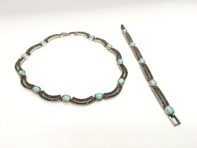 A silver bracelet and necklace set with marcasite