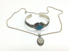 A moonstone pendant on a silver chain and a silver