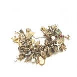 A heavy 9ct gold charm bracelet set with a large n