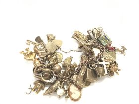 A heavy 9ct gold charm bracelet set with a large n