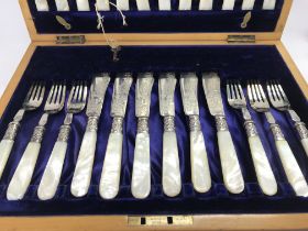 A cased set of silver fish knifes and forks with m