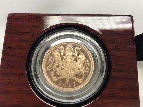 A 2022 gold proof sovereign. Postage B