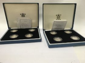 Two sets of four silver proof Â£1 coins.
